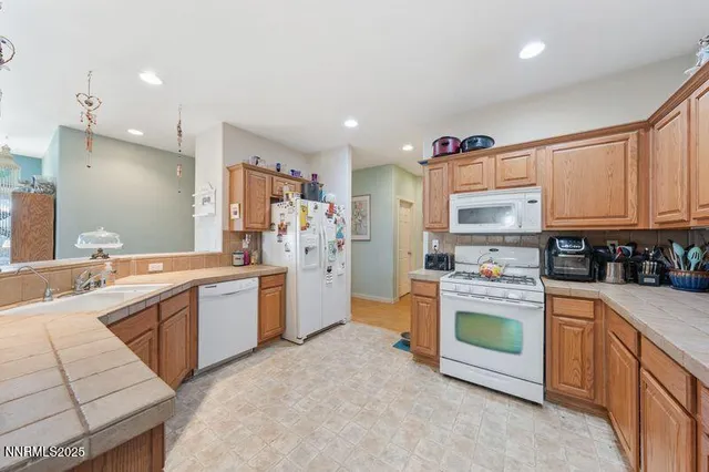 a kitchen with stainless steel appliances and white cabinets