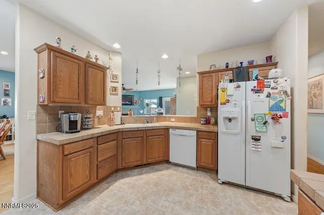 a kitchen with stainless steel appliances granite countertop a refrigerator sink and cabinets