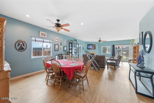 a view of a dining room with furniture and wooden floor