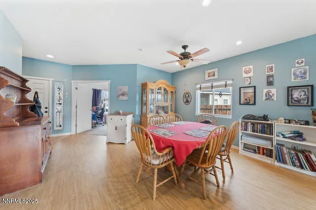 a living room with kitchen island granite countertop wooden floor and a fireplace