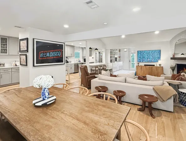 a living room with furniture and kitchen view