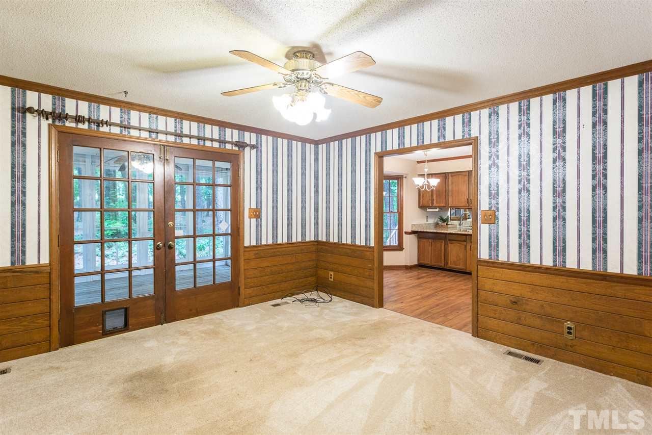 10005 Bavin Place Raleigh, NC 27613 - Photo 11 of 30 a bedroom with a large bed and a chandelier