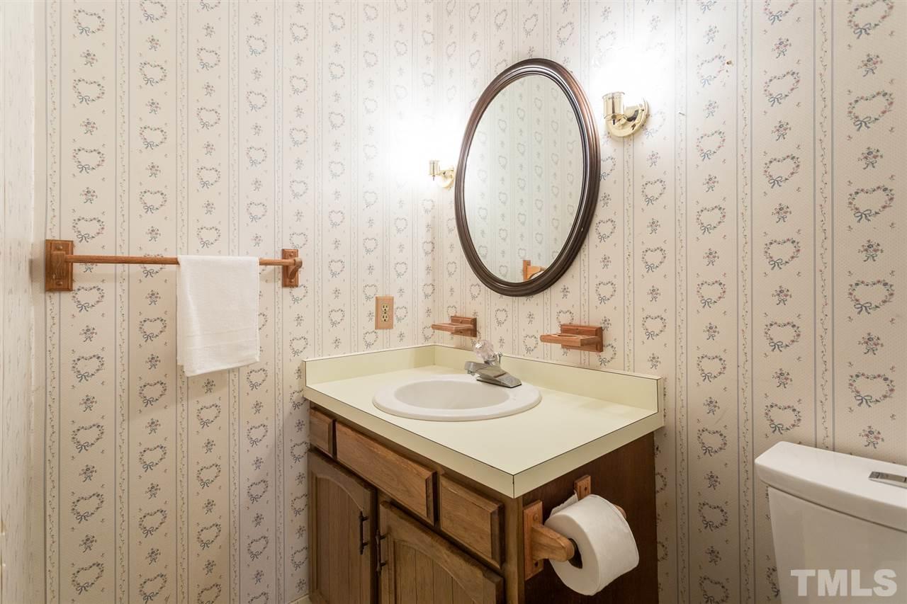 10005 Bavin Place Raleigh, NC 27613 - Photo 12 of 30 a bathroom with a sink and a mirror