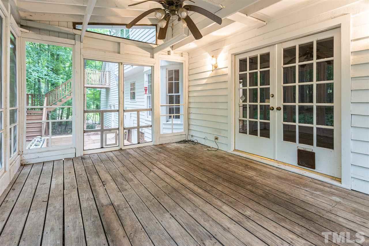 10005 Bavin Place Raleigh, NC 27613 - Photo 24 of 30 a view of empty room with windows and wooden floor