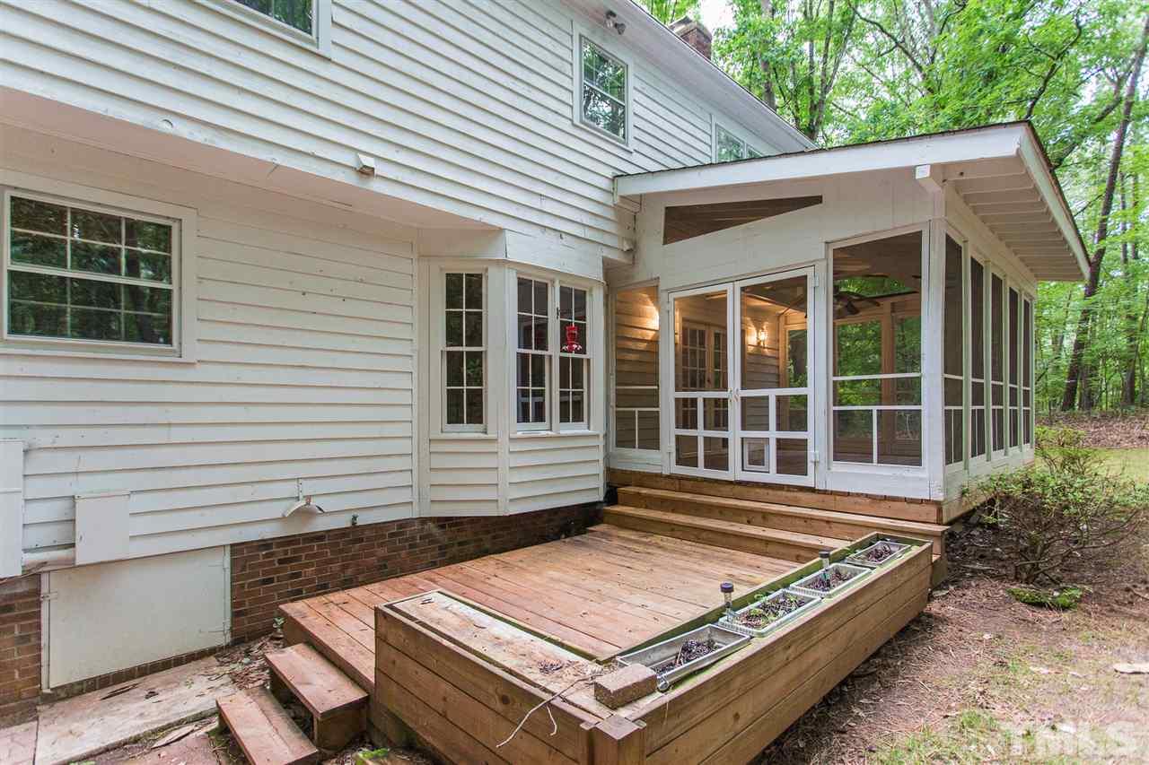 10005 Bavin Place Raleigh, NC 27613 - Photo 25 of 30 a view of a roof deck with chair and table and chairs with wooden floor and fence