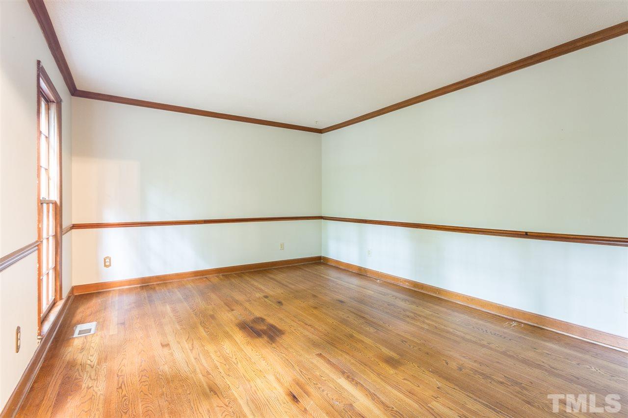 10005 Bavin Place Raleigh, NC 27613 - Photo 4 of 30 a view of an empty room with wooden floor