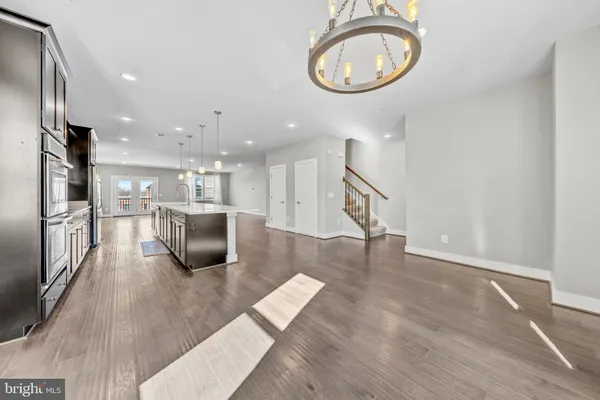 a view of kitchen with furniture and a chandelier