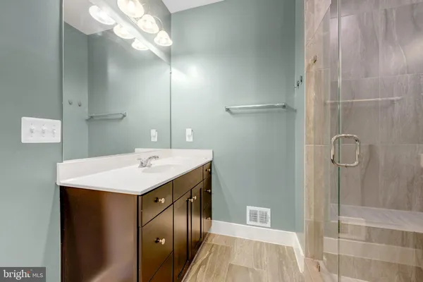a bathroom with a sink a mirror and a shower