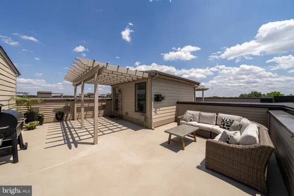 a view of a patio with dining table and chairs with a barbeque grill and a fireplace