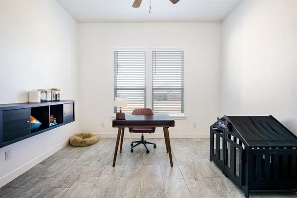 a spacious bedroom with a bed and a flat tv screen