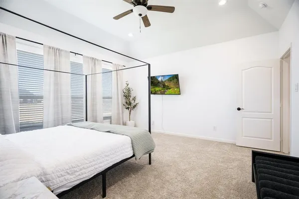 a bedroom with a bed and window