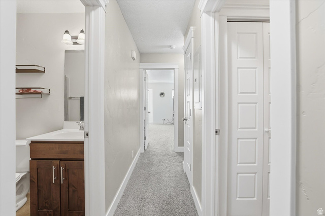 1024 South 270 West Logan, UT 84321 - Photo 27 of 37 Hall featuring light colored carpet and a textured ceiling