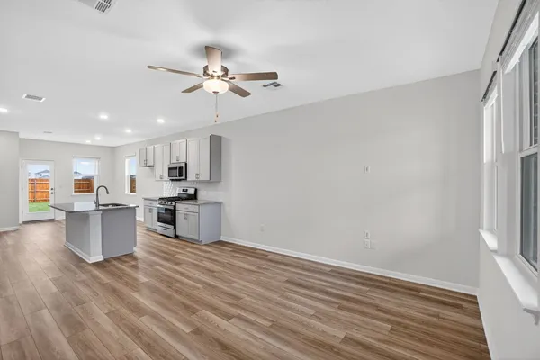 a living room with kitchen island furniture and a kitchen view