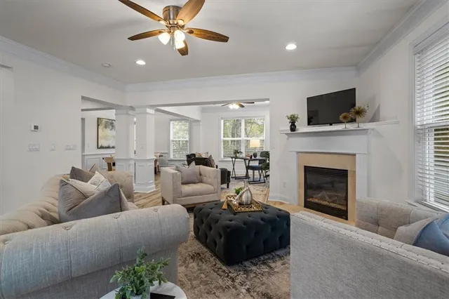a living room with furniture a fireplace and a flat screen tv