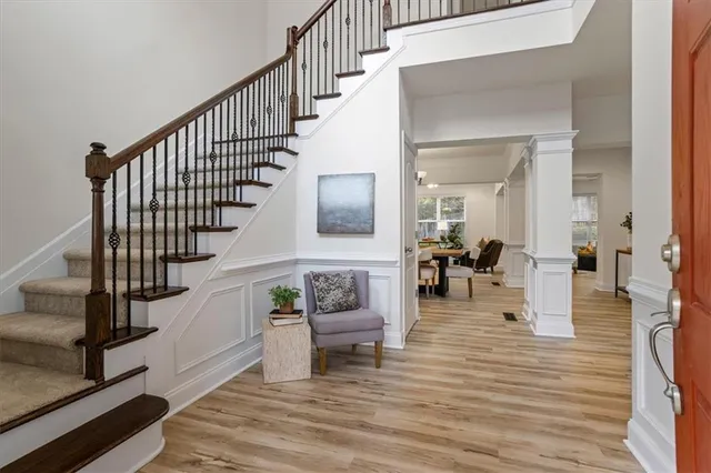 a view of entryway and hall with wooden floor