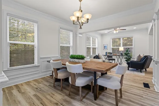 a view of a dining room with furniture wooden floor and chandelier