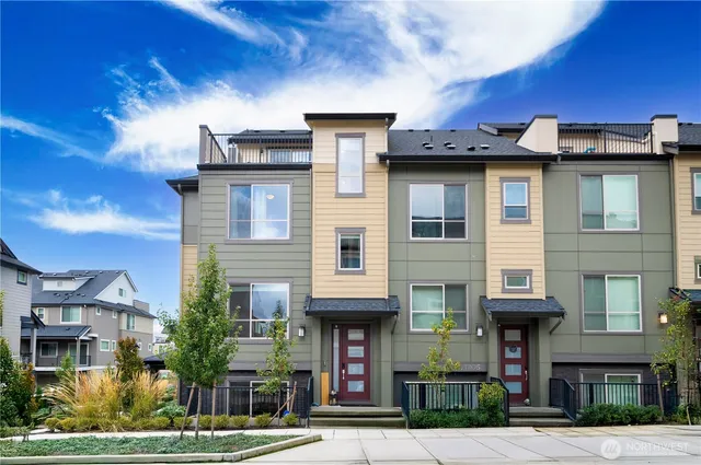 a front view of a residential apartment building with a yard