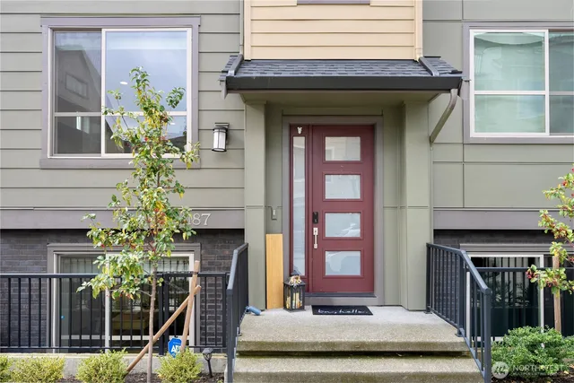 a front view of a house with plants