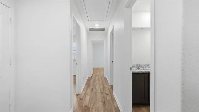 a view of a hallway with wooden floor