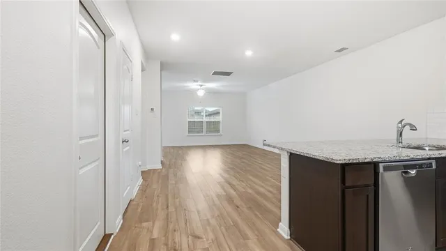 a view of a kitchen from a hallway