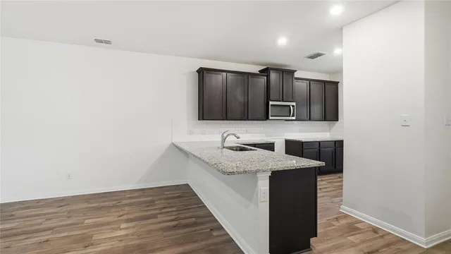 a kitchen with a sink and cabinets