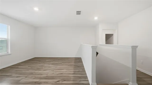 a view of hallway with wooden floor