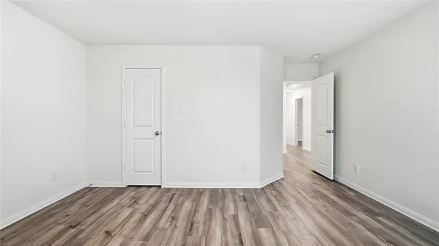 a view of an empty room and wooden floor