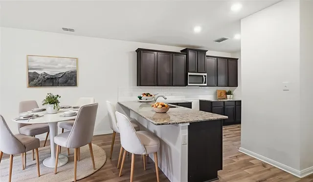a kitchen with a table and chairs in it