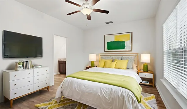 a bedroom with a bed and a flat screen tv