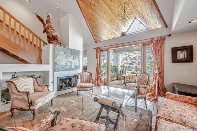 a living room with furniture and a floor to ceiling window