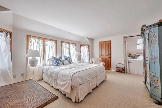 a bedroom with a bed and a large mirror