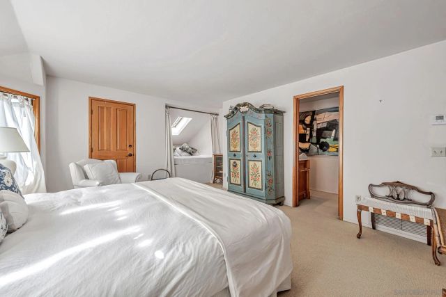 a bedroom with a bed closet and a window