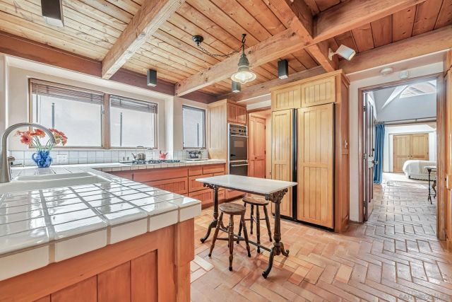 a view of a dining room with furniture and a chandelier