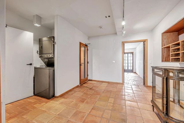 a view of a hallway with wooden floor and a kitchen