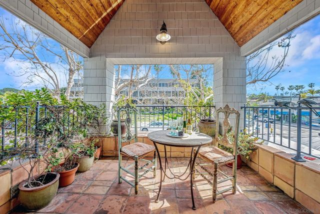a view of a patio with a table and chairs and potted plants