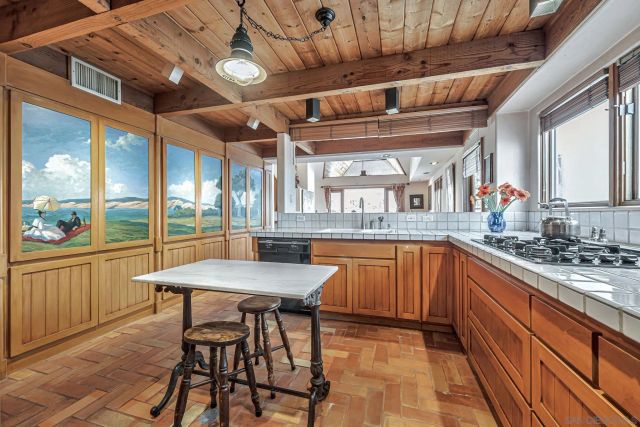 a kitchen with stainless steel appliances granite countertop a sink and wooden cabinets