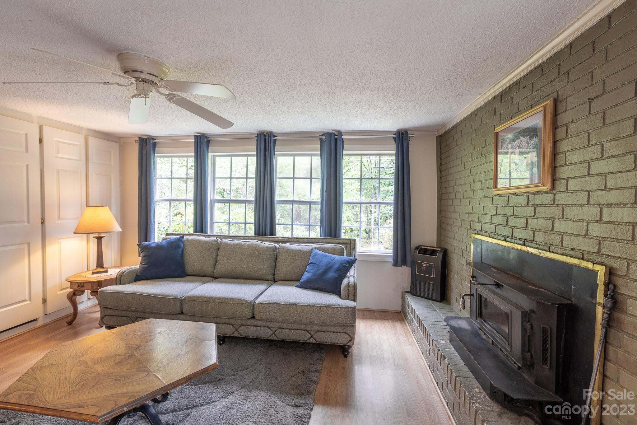 777 Glenn Bridge Road Arden, NC 28704 - Photo 12 of 22 a living room with furniture and a fireplace