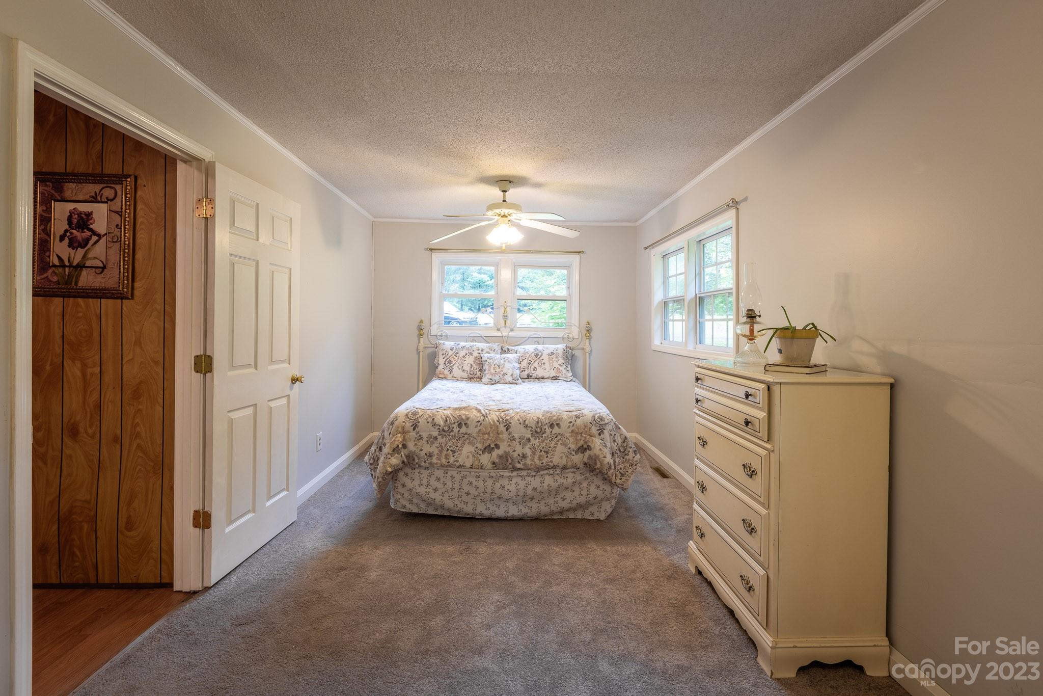 777 Glenn Bridge Road Arden, NC 28704 - Photo 13 of 22 a room with a bed and a dresser