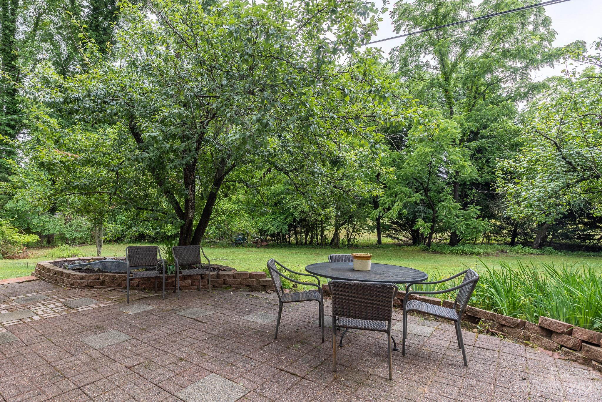 777 Glenn Bridge Road Arden, NC 28704 - Photo 20 of 22 an outdoor sitting area with a table and chairs