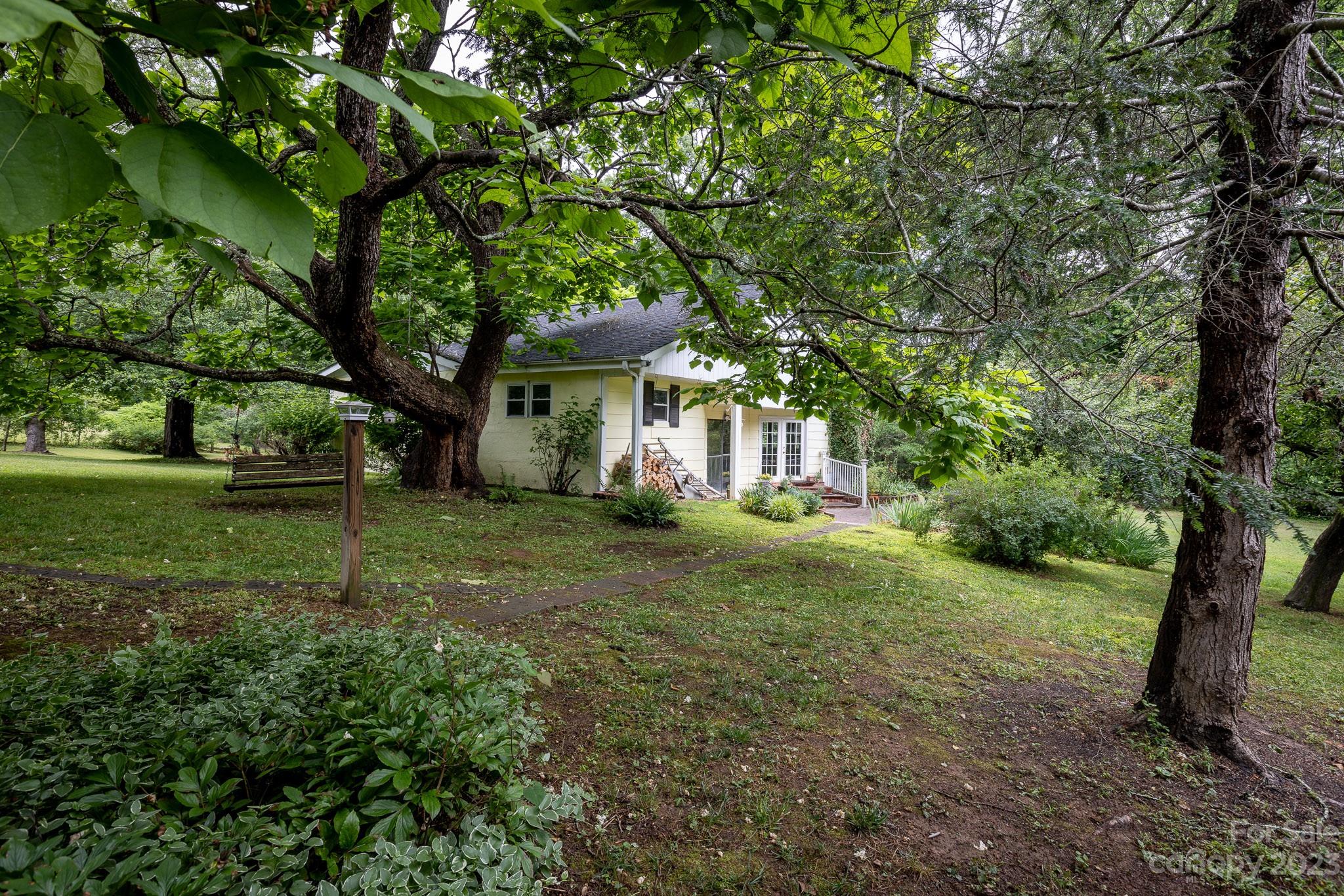 777 Glenn Bridge Road Arden, NC 28704 - Photo 3 of 22 a view of a house with yard and sitting area