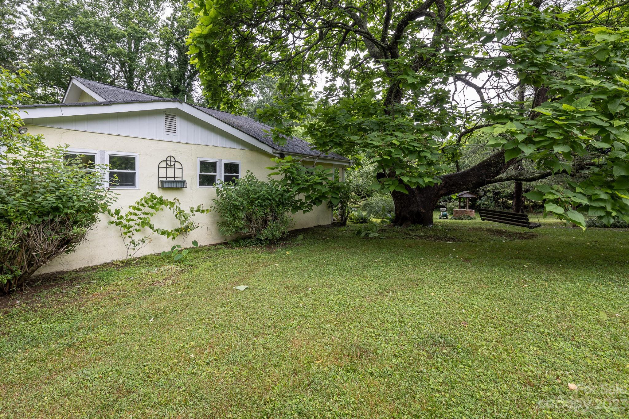777 Glenn Bridge Road Arden, NC 28704 - Photo 5 of 22 a view of a backyard with plants and large trees