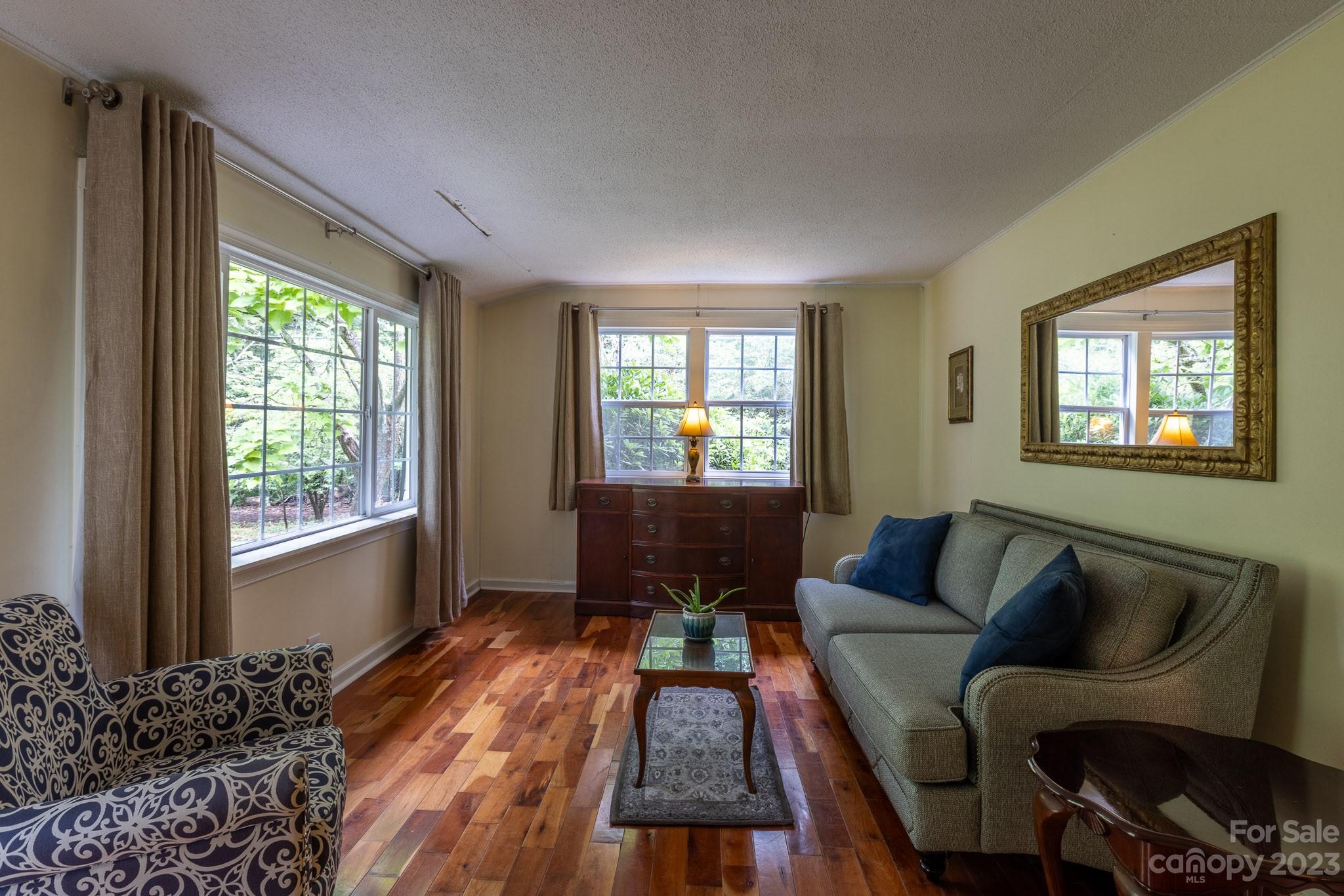 777 Glenn Bridge Road Arden, NC 28704 - Photo 8 of 22 a living room with furniture and a window