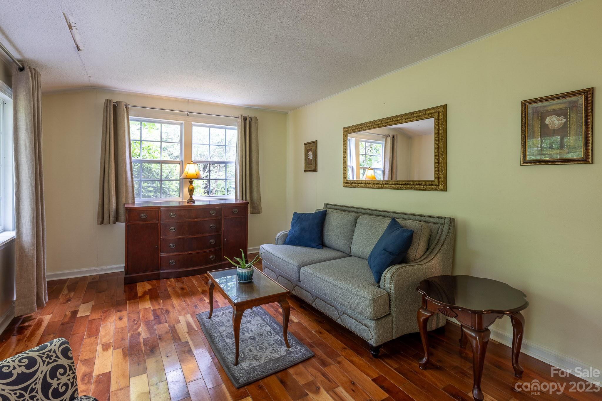 777 Glenn Bridge Road Arden, NC 28704 - Photo 9 of 22 a living room with furniture and a wooden floor