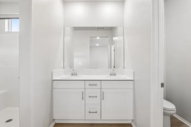 a bathroom with a double vanity sink and mirror