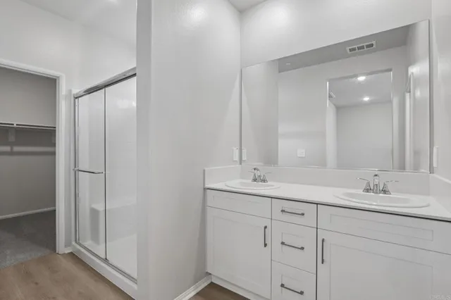 a bathroom with a glass shower door