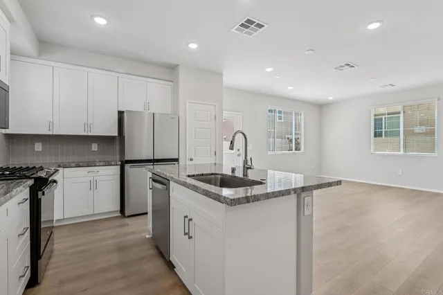 a kitchen with a sink stove and refrigerator