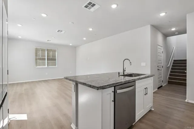 a kitchen that has a sink and a stove in it