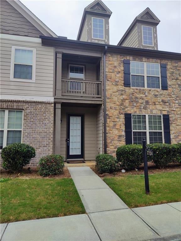 7736 Rutgers Circle Fairburn, GA 30213 - Photo 1 of 39 a front view of a house with a garden
