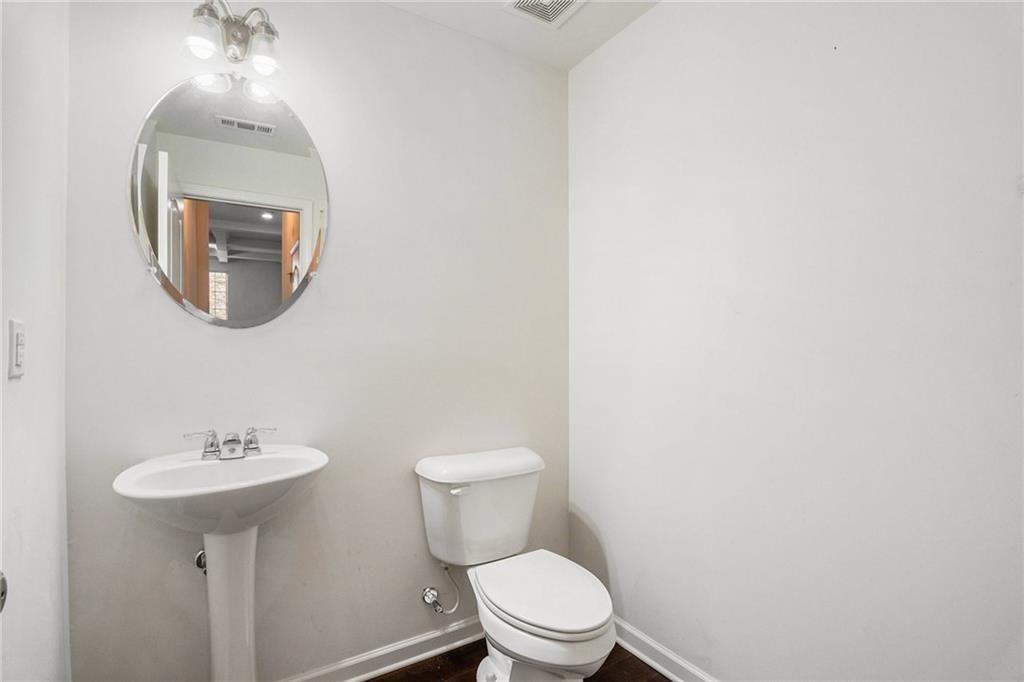 7736 Rutgers Circle Fairburn, GA 30213 - Photo 11 of 39 a white toilet sitting next to a bathroom sink