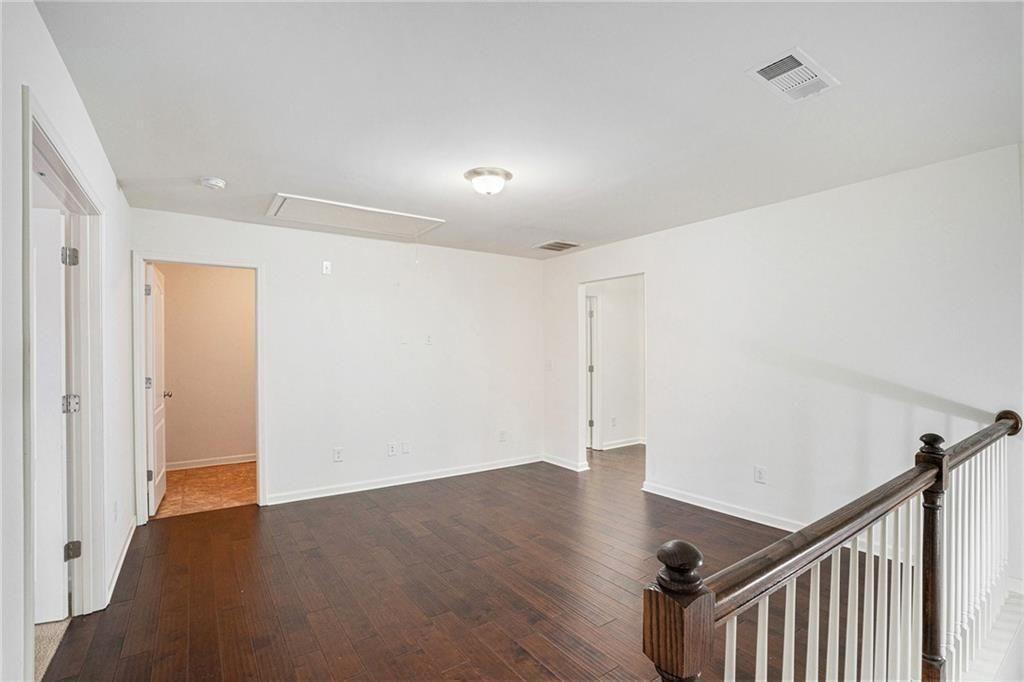 7736 Rutgers Circle Fairburn, GA 30213 - Photo 12 of 39 a view of an empty room with wooden floor